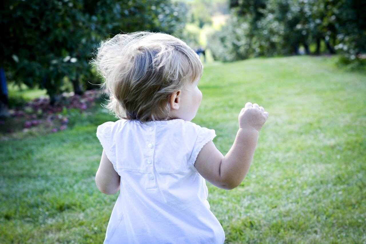 baby running in the yard