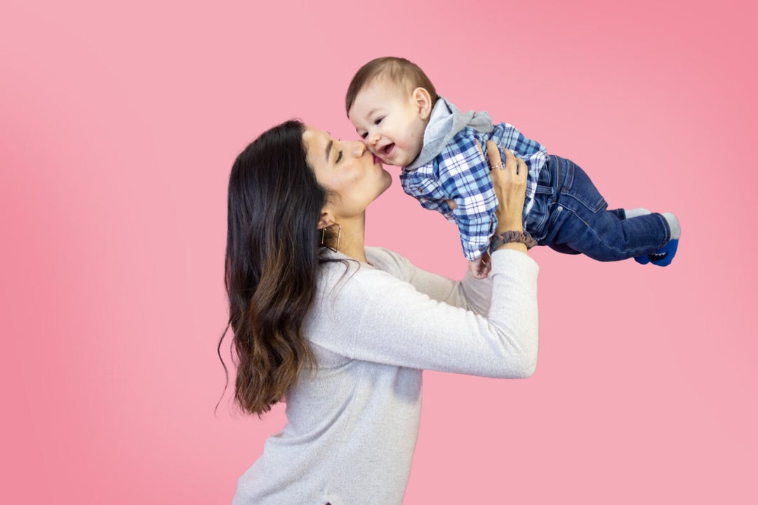 Mom kissing her baby’s cheek