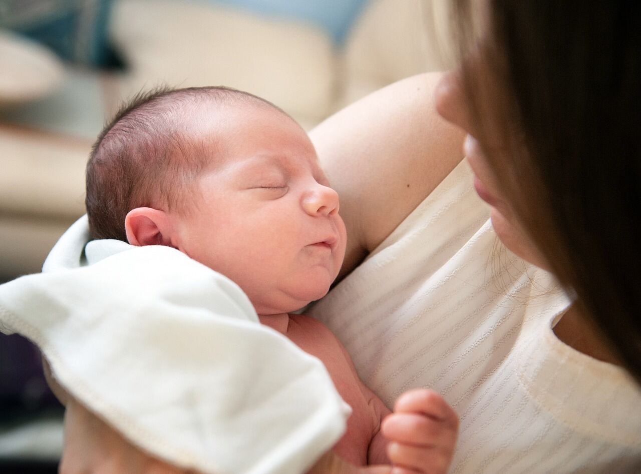 mom looking down at baby