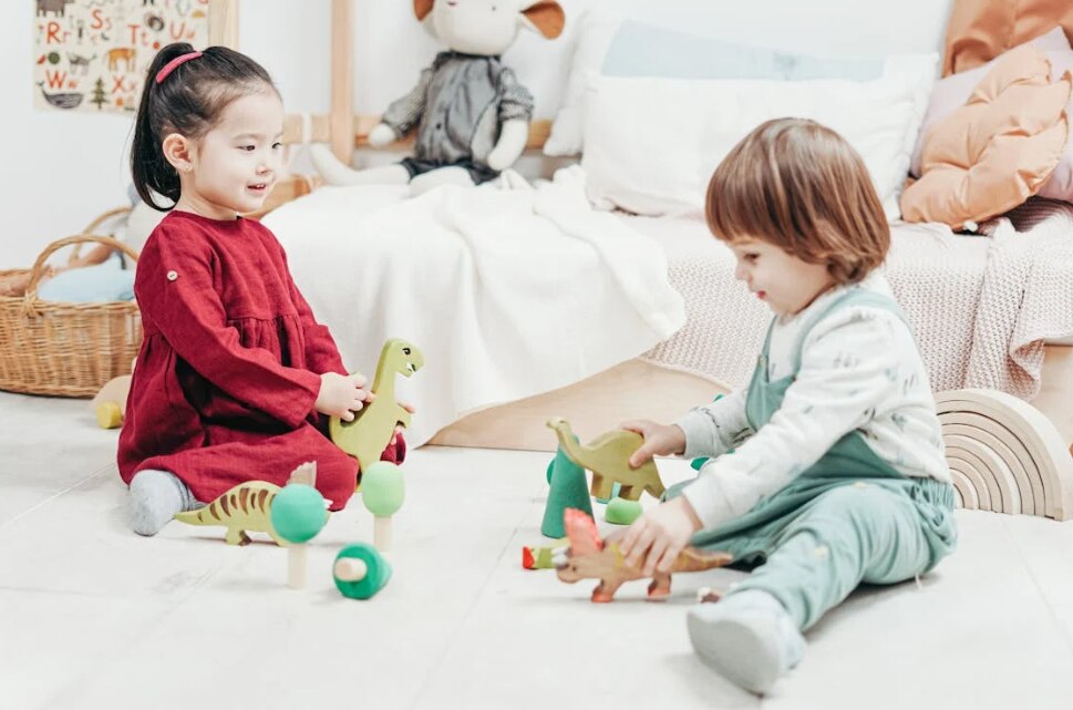 Two toddlers playing with toys 