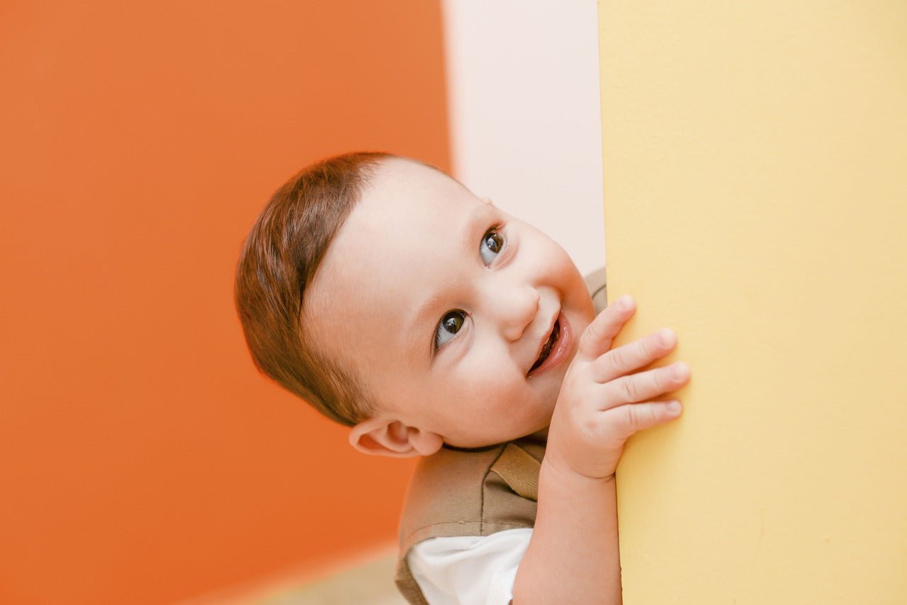 young boy peeking around the corner