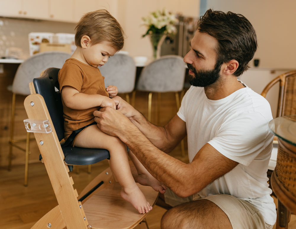 dad putting child on highchair