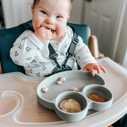 Baby enjoying food on the froggy shaped Abiie Octopod Grip Dish