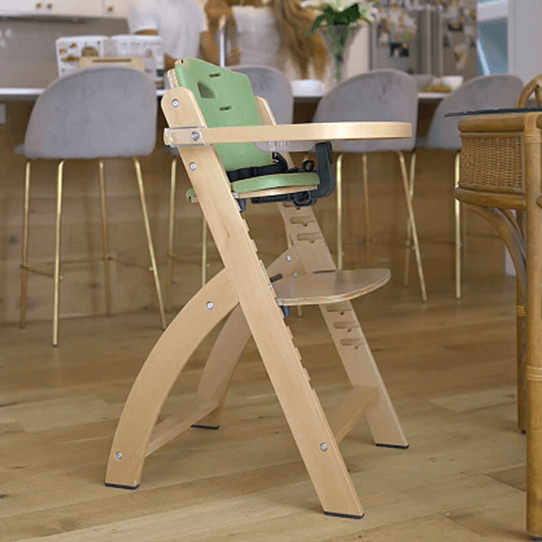 Happy baby is sitting in the Abiie Beyond Junior High Chair